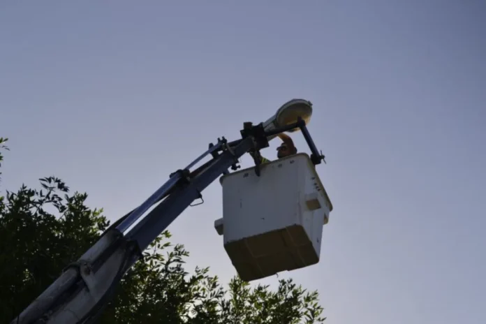 Trabajador municipal instalando una luminaria LED en una calle de Gualeguaychú
